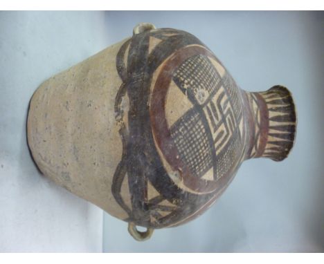 A Chinese (probably Yangshao) Neolithic earthenware jar of ovoid form, having opposing ring handles, a narrow neck and flared