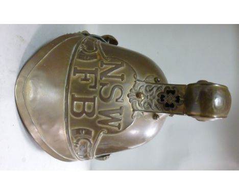 An Australian (New South Wales) firefighter's brass helmet with a chain covered hide chinstrap, impressed with dragons on the
