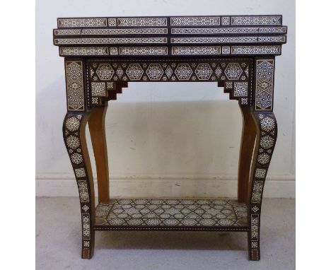 An early/mid 20thC Turkish walnut games table with elaborate bone and ebony parquetry ornament, having a rotating foldover, s