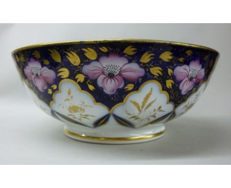 A late 18th/early 19thC New Hall porcelain punch bowl, decorated in iron red and pink on a midnight blue ground with uniform 