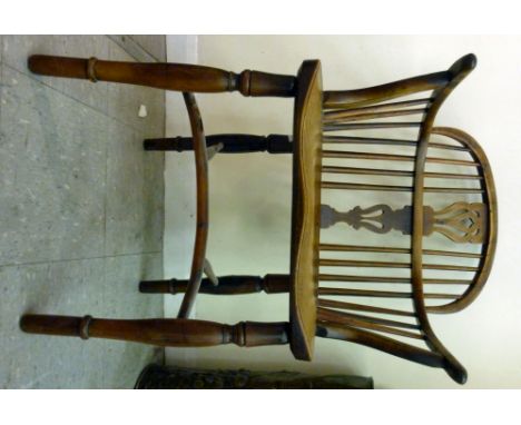 A mid/late 19thC yew and elm framed Windsor low hoop and stick back chair, having a pierced splat and level arms, the solid s