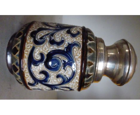 A Doulton Lambeth stoneware tea caddy of footed, bulbous form, decorated in tones of blue, green and brown with stylised orga