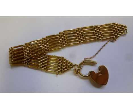 An 18ct gold six bar gate bracelet with a heart shaped lockable clasp