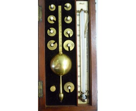 An early 20thC lacquered brass Sikes Hydrometer, in a fitted, maroon fabric lined mahogany case, the engraved ivory backplate