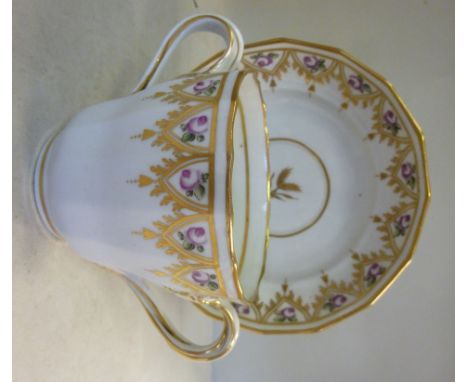 A late 18thC New Hall porcelain, wavy edged, twin loop handled cup and saucer, decorated in colours with floral borders and g