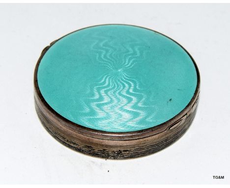 A silver ladies compact with green enamel turned top