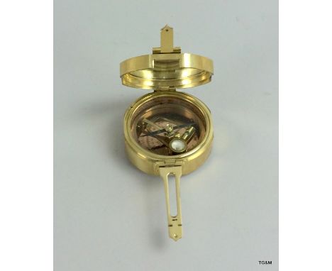 a brass cased compass and sun dial