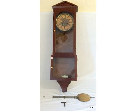 A mahogany pendulum clock with key