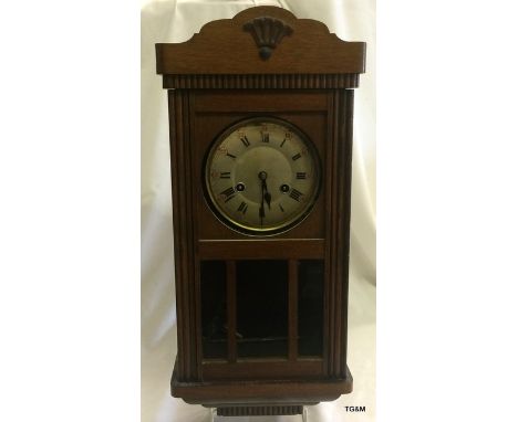 An Oak Cased Wall Clock complete with Key