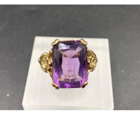 A large emerald cut amethyst ring on heavy fancy mount 9ct size R 6.5 gms