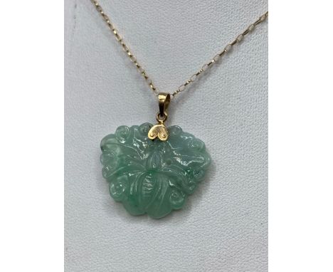 A jade and gold carved butterfly pendant 14ct gold with gold chain 18 inch