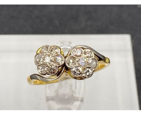 A twist diamond cluster ring set in gold size M 2.6 gms