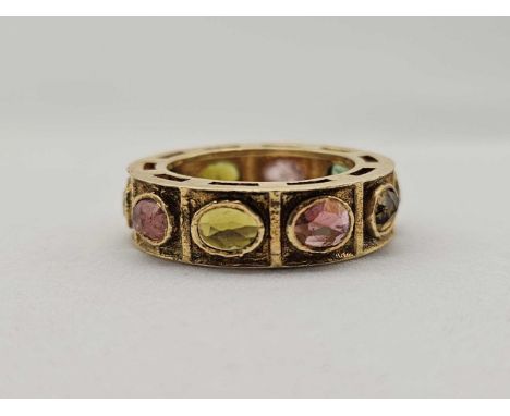 A large eternity ring 18ct gold with assorted coloured tourmalines 6.4 g size O