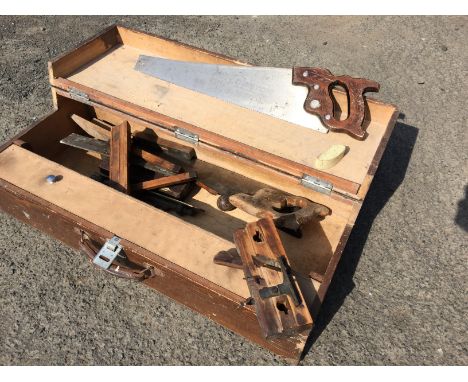 A joiners tool box with tools including a brass plane with brass mounted guide, disston saws, two large brass sliding bolts a
