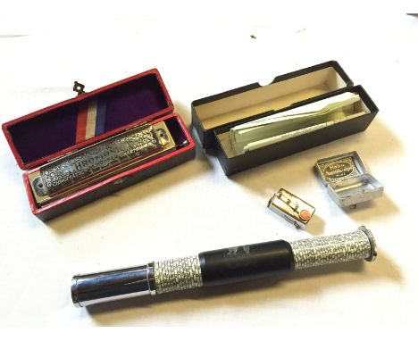 A mechanical calculator a mouth organ and an Autoknips camera timer.