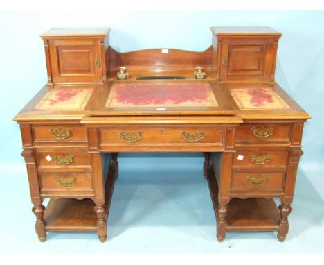 A late-Victorian walnut estate/office desk, the top with two small cupboards enclosing pigeon holes and drawers, recess for i