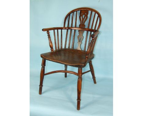 A 19th century yew wood stick-back Windsor armchair, with elm seat and back legs joined by a crinoline stretcher and another 