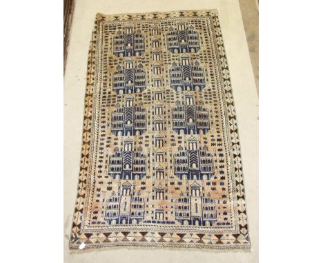 A late-20th century wool rug, the light ground with two rows of architectural form and smaller architectural features, 236cm 