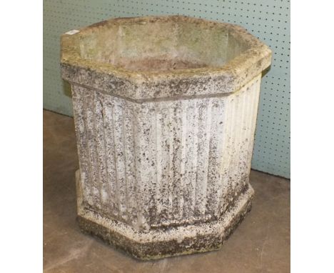 An octagonal cast concrete fluted planter, 52cm high and a similar square planter, (2).
