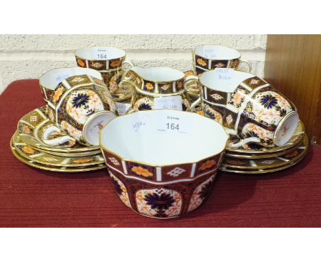 A Royal Crown Derby Imari pattern part tea service comprising of six cups and saucers, six side plates, a slop bowl and a cre