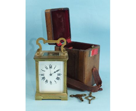 A 19th century French brass carriage clock with gong-striking movement and white enamel dial, 18cm high, in travelling case.