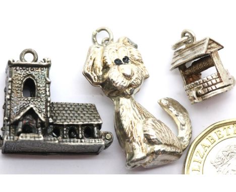 Three 70s vintage silver charms, Church, well and dog. P&amp;P Group 1 (£14+VAT for the first lot and £1+VAT for subsequent l