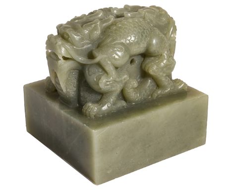 A CHINESE CELADON JADE 'DRAGON' SEAL the square seal surmounted by a pair of addorsed dragons, each with bulging eyes and gap