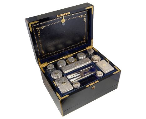 ˜A VICTORIAN SILVER FITTED BRASS-BOUND EBONY DRESSING CASE, RETAILED BY F. WEST, LONDON, 1860 the silver fittings all engrave