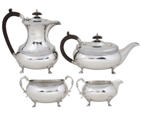 A SILVER FOUR-PIECE TEA SET, POSTON PRODUCTS LTD., SHEFFIELD, 1970 the bulbous oblong bodies each applied with a Celtic patte