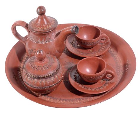 A TOPHANE TEA SET, ISTANBUL, TURKEY, LATE 19TH CENTURY burnished red terracotta, comprising a tray, two cups and saucers, a s