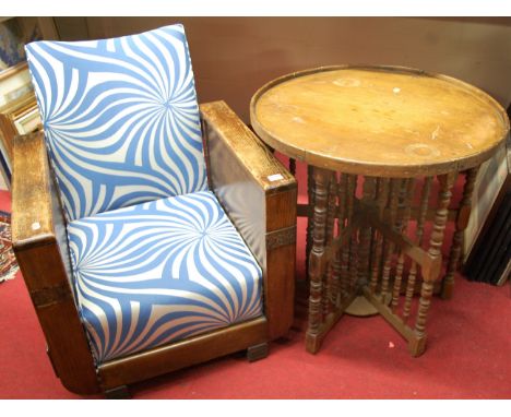 A 1930s oak framed armchair; together with a beechwood and bobbin turned circular topped occasional table (2)