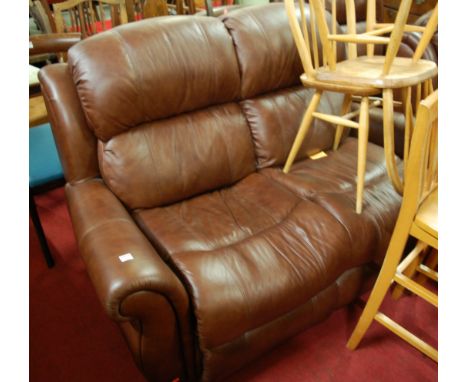 A contemporary tan leather upholstered three piece suite comprising; two seater sofa and a pair of armchairs