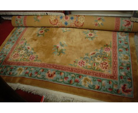 A Chinese Superwash carpet, the beige ground decorated with flowers and foliage within a border, w.270cm