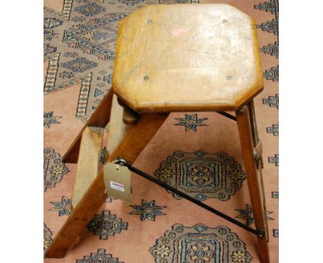An early 20th century light oak folding set of library steps having iron supports