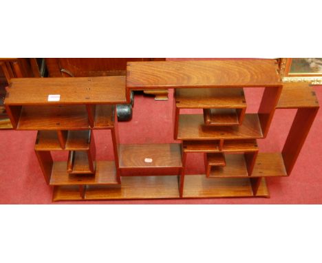 A contemporary Chinese hardwood table-top collectors display shelf, of open abstract form with exposed joints, w.90cm