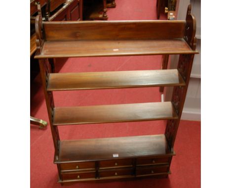 A contemporary hardwood four-tier hanging wall shelf, having six short lower drawers. w.75cm