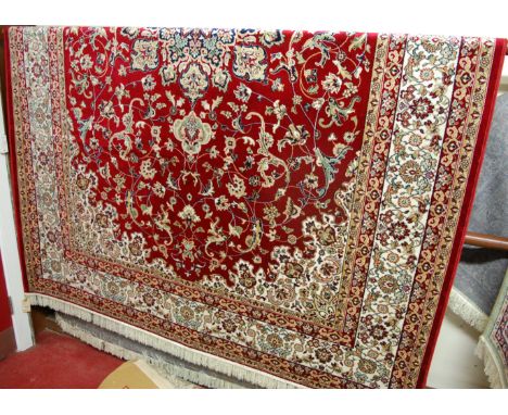 A machine-woven Persian woollen red ground kashan carpet, 300 x 200cm