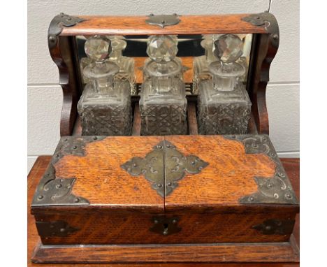A Victorian oak tantalus of miniature size (H19cm W25cm)