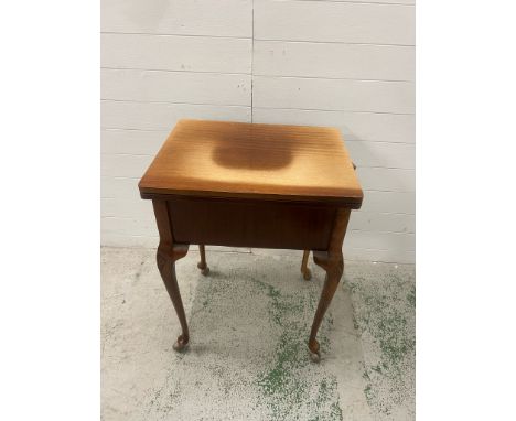 A Hillman case sewing machine on cabriole legs fitted with casters 