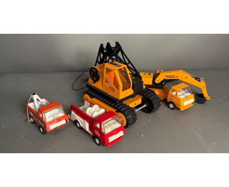 A selection of vintage playworn Tonka toys to include movers and trucks 