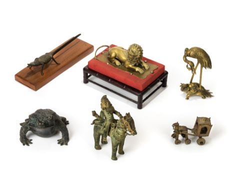 *Bronze. A Chinese bronze toad,  well detailed with scaly skin, 19cm long, together with a brass Buddhistic lion, modelled ly