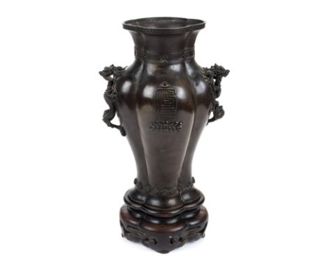 *Vase. A 19th century Chinese bronze vase,  of lobed baluster form, with two Buddhist symbols finely cast dragon handles each