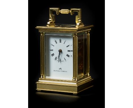*Carriage Clock. A modern brass carriage timepiece by Matthew Norman,  with white enamel dial black roman numerals, Swiss mad