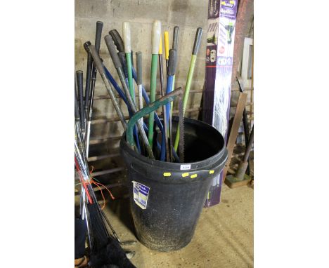 A dustbin lacking lid and a quantity of garden tools