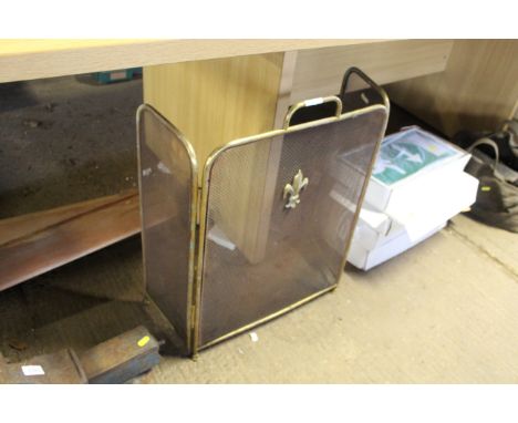 A folding brass fireguard