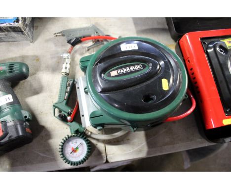 A Parkside air hose reel together with tyre pressure attachment and other tools