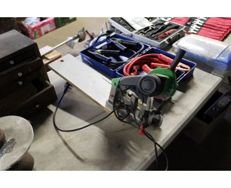 A chainsaw sharpener on wooden plinth