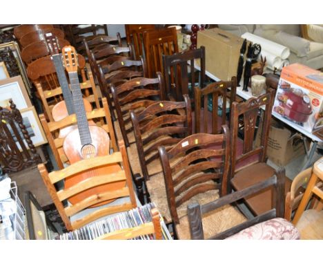Six oak rush-seated ladder-back chairs similar elbow chair and one other elbow chair