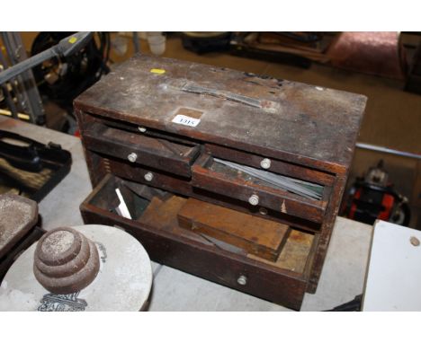 A small wooden chest of drawers and contents of tools
