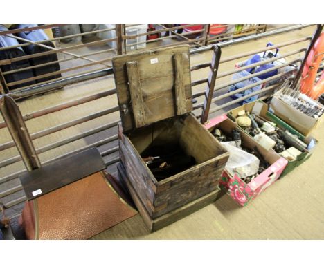 A wooden box containing tools, frying pan etc